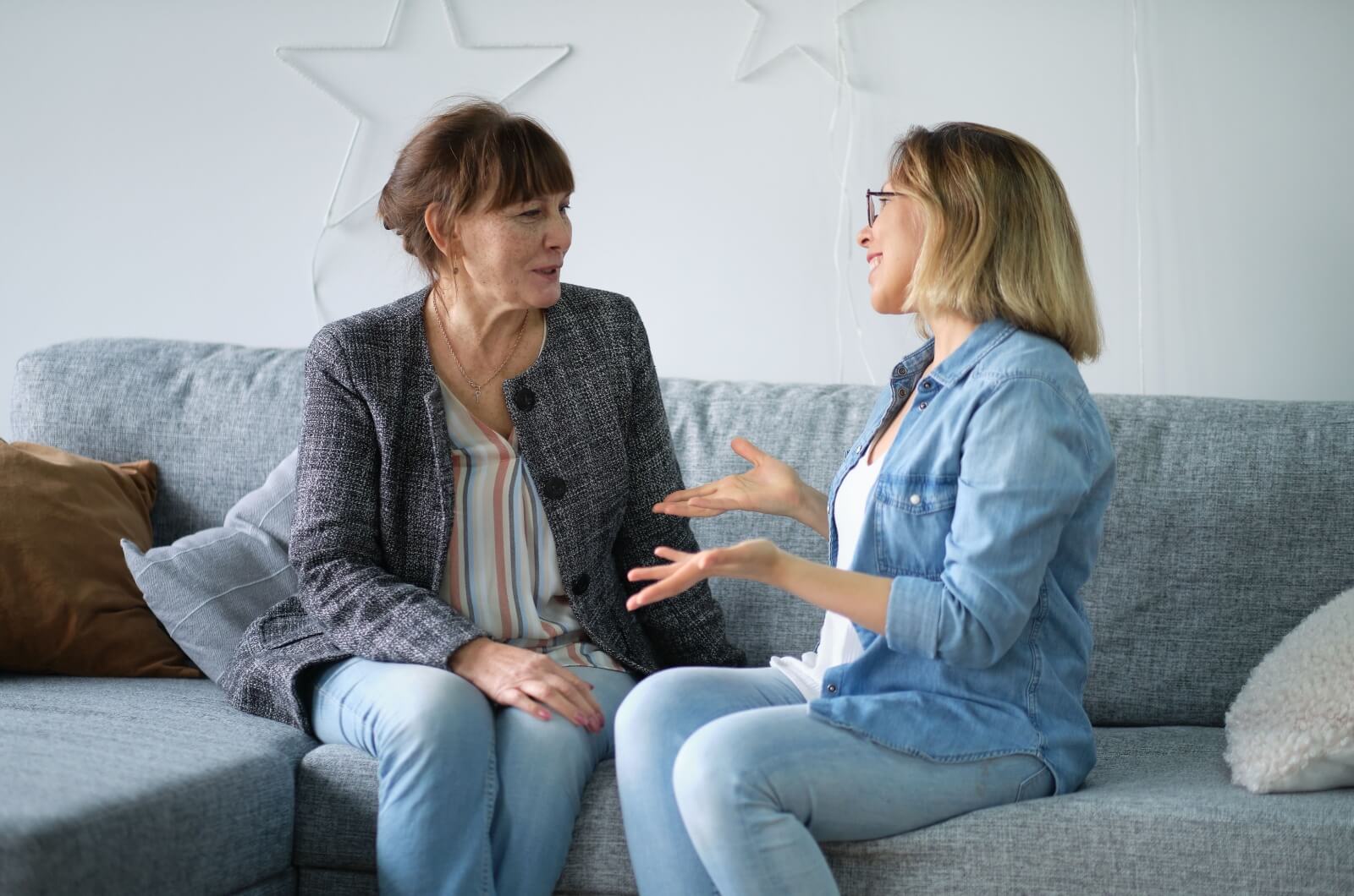 A senior and their adult child discuss future memory care community plans.