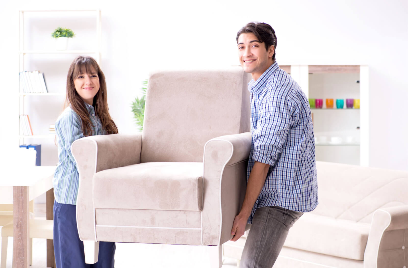 Siblings moving a chair to help their parents downsize.